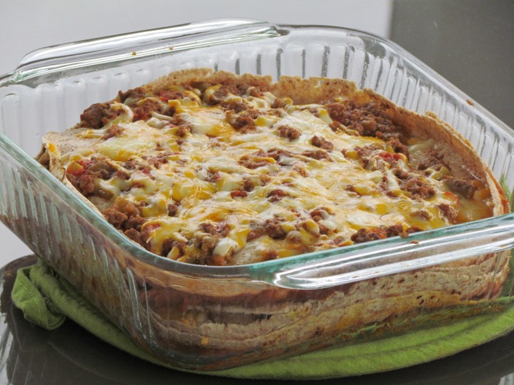 Layers of tortillas, meat, cheese, and refried beans makes this mexican-style lasagna a family favorite