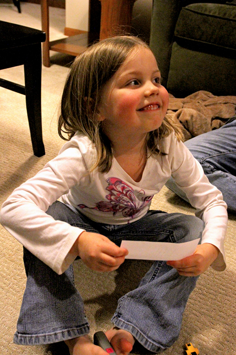 little girl playing apples to apples 