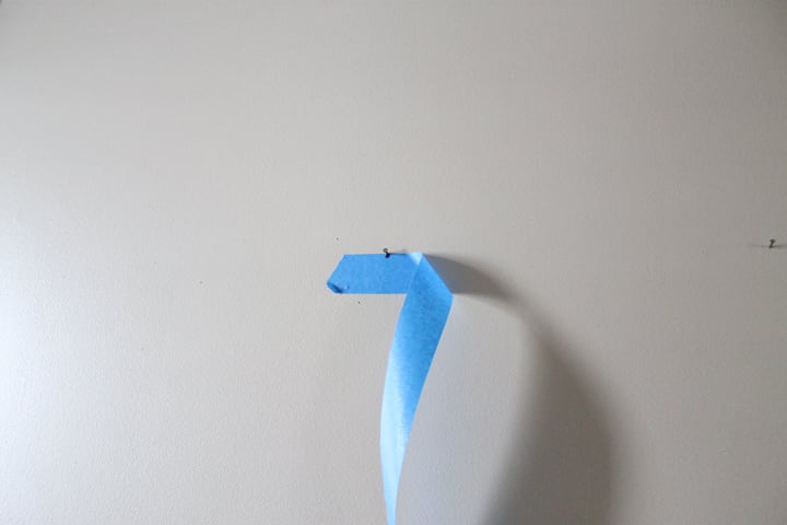 Peeling painters tape off the wall