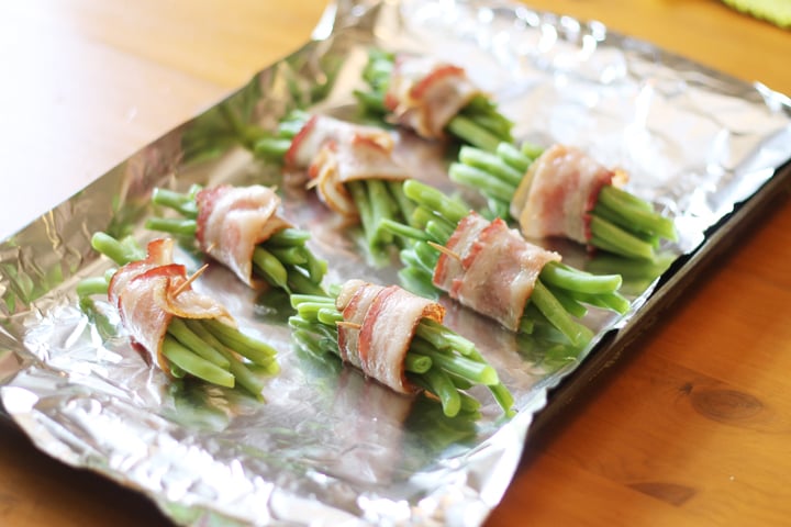 Bacon-wrapped green beans on a foil lined pan