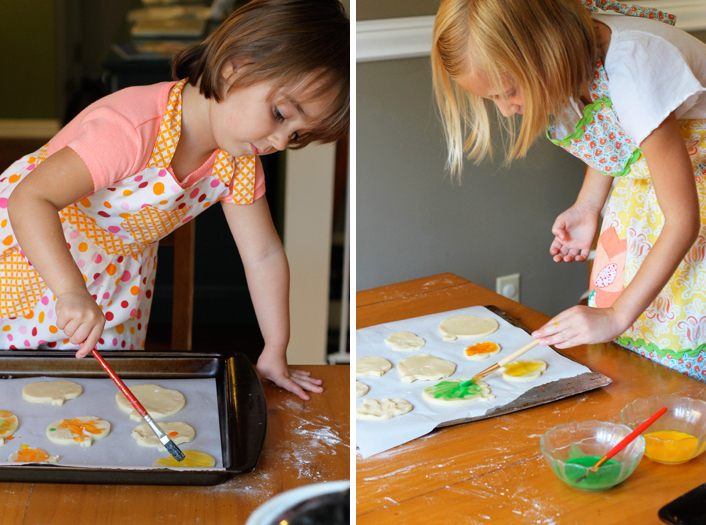 painting pumpkin cookies with icing