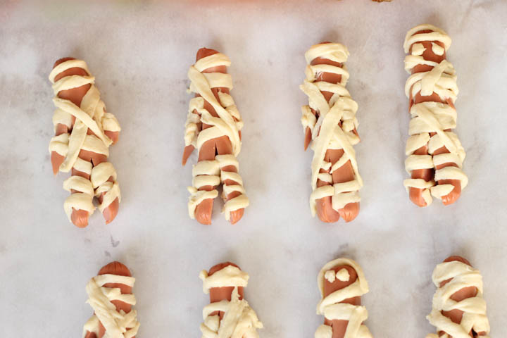Uncooked hot dogs wrapped in uncooked crescent rolls. 