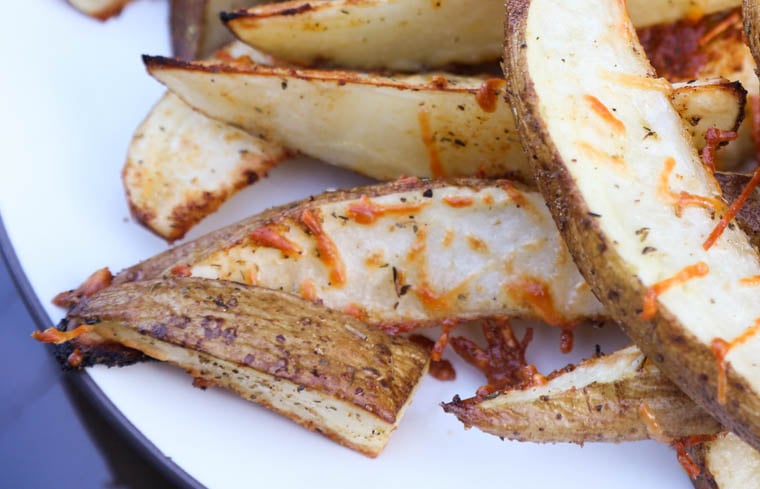 A close up of cooked parmesan potato wedges