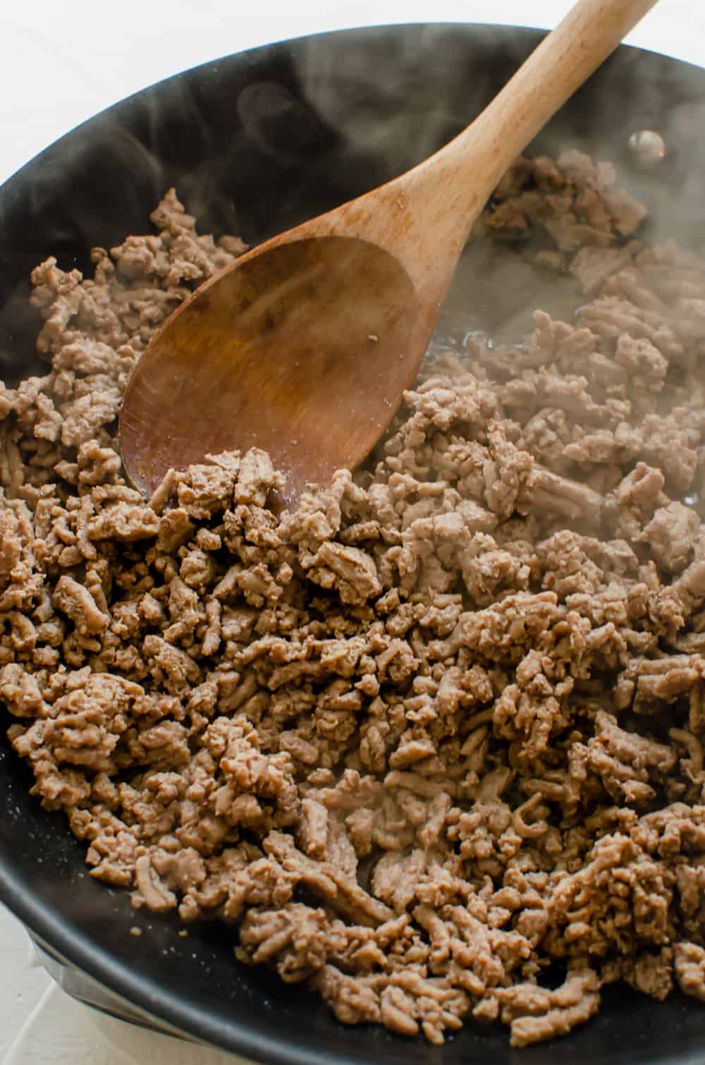 ground chicken being browned in a skillet