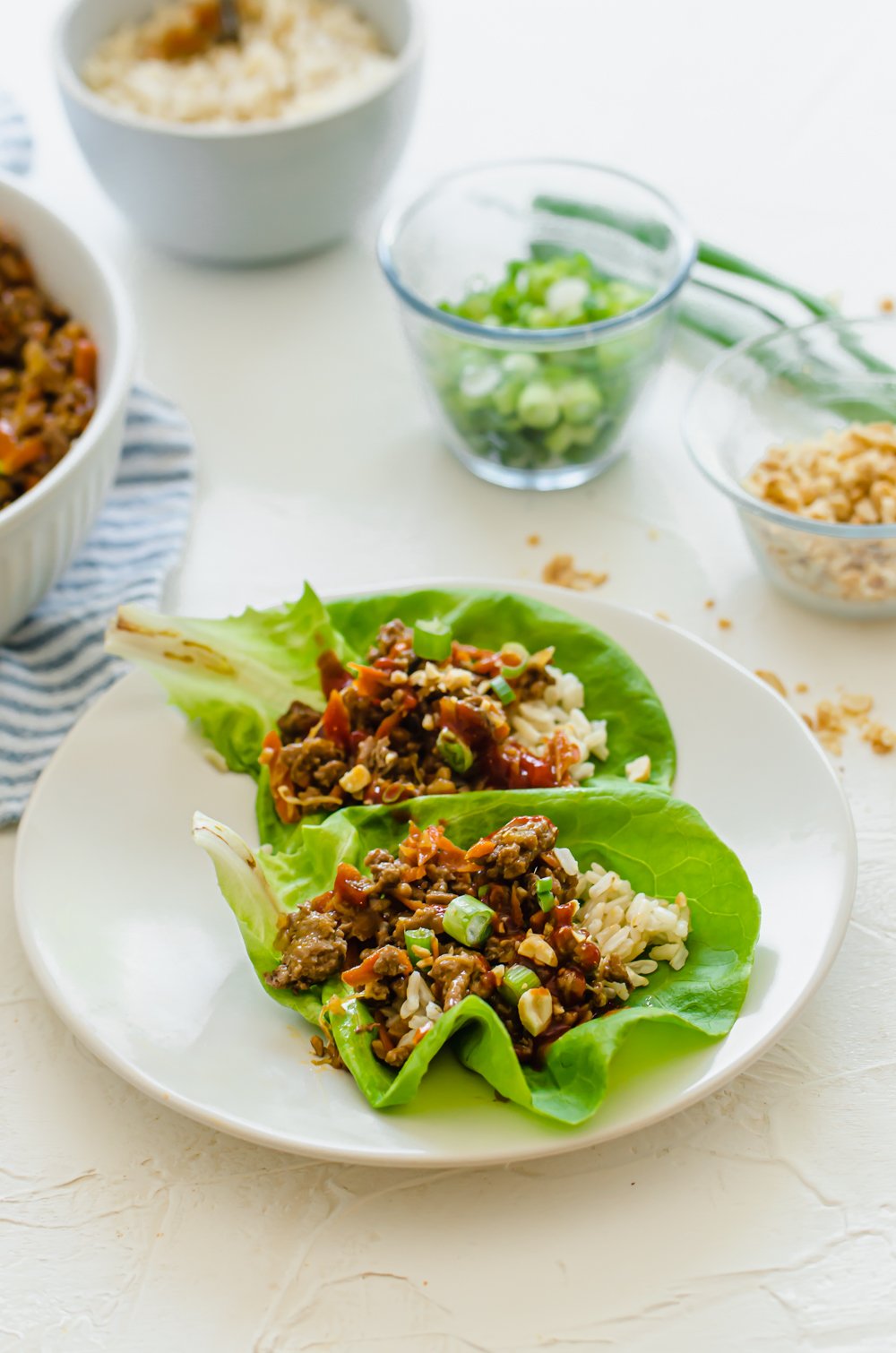 a plate with two lettuce wraps on it