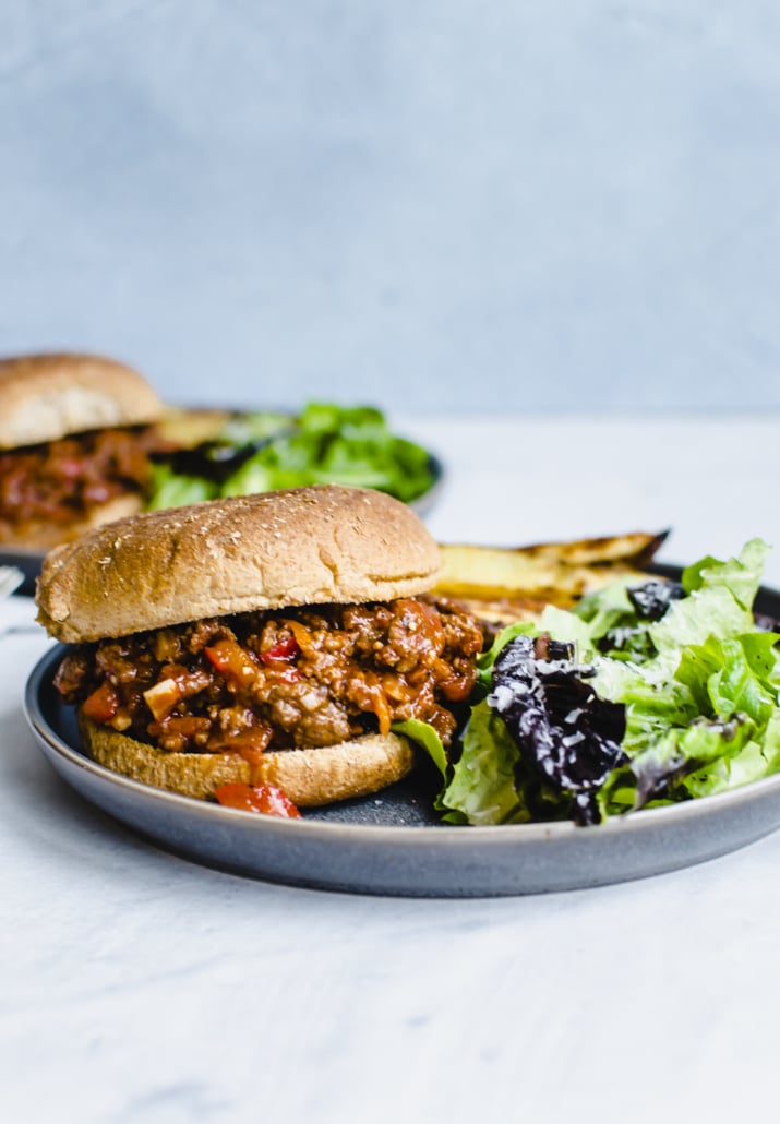 Instant Pot sloppy joes on a bun with a side of salad 
