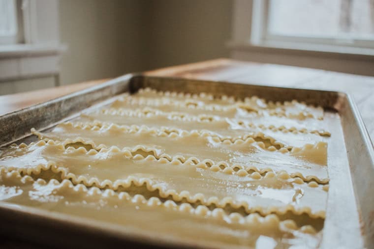 Cooked lasagna noodles on a baking sheet