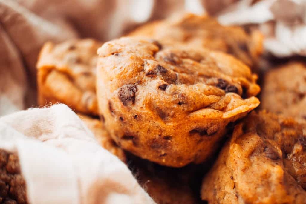 Close up of pumpkin chocolate chip muffins in a basket