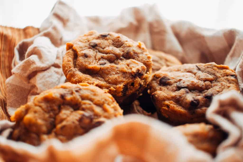 pumpkin chocolate chip muffins in a basket