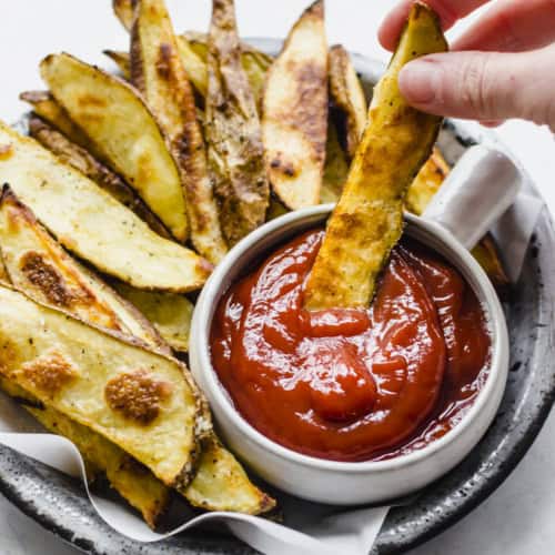 steak fries dipped in ketchup
