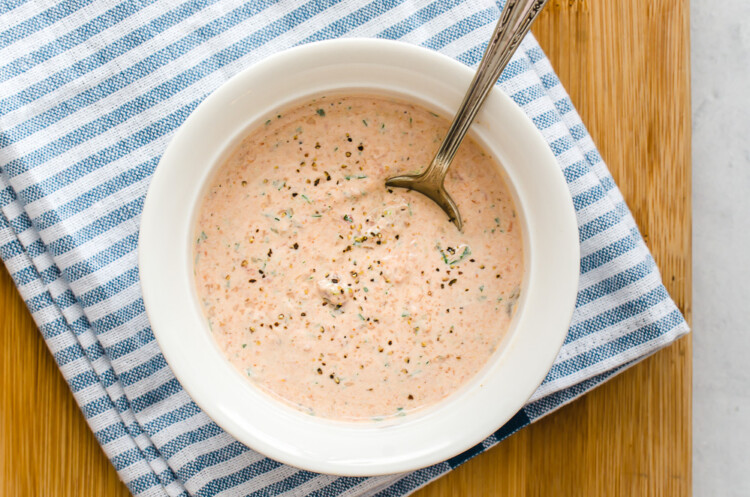 Creamy southwest ranch dressing in a white bowl with a spoon for serving.