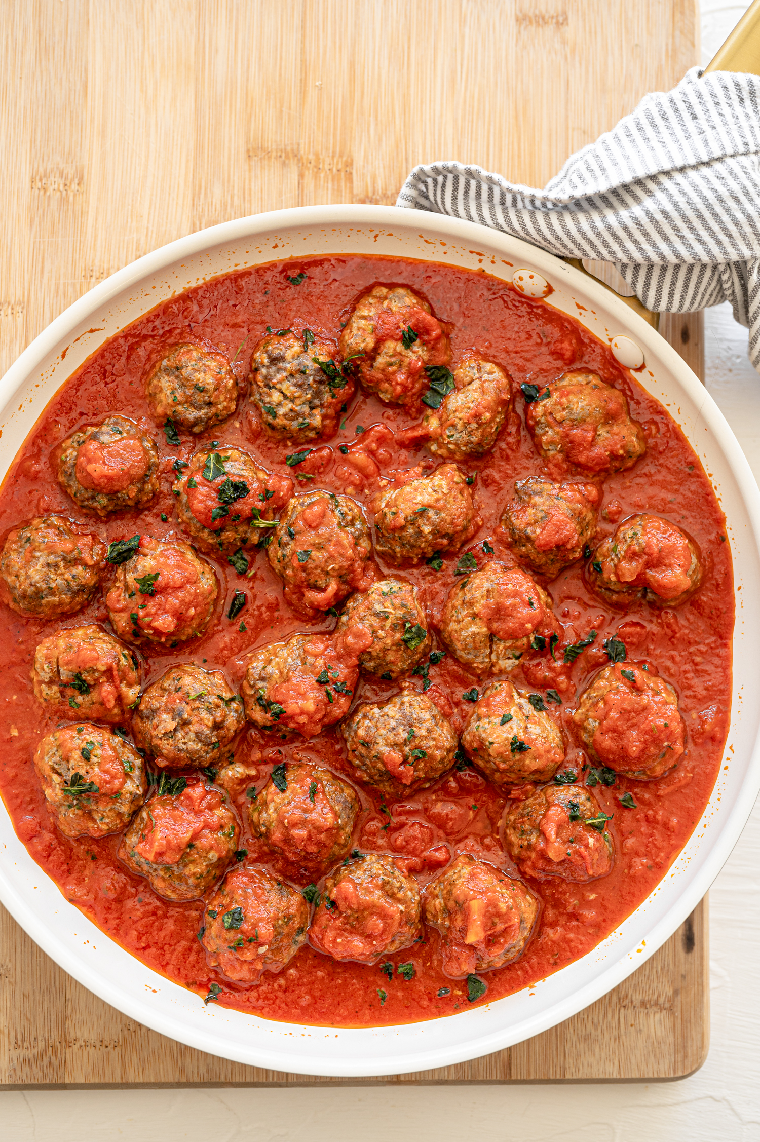 A shallow platter with meatballs and sauce.
