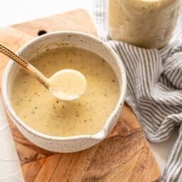 Cream of Chicken Soup being ladled out of a small serving dish.