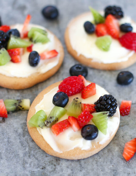 Fruit pizza cookies on a slate serving platter.