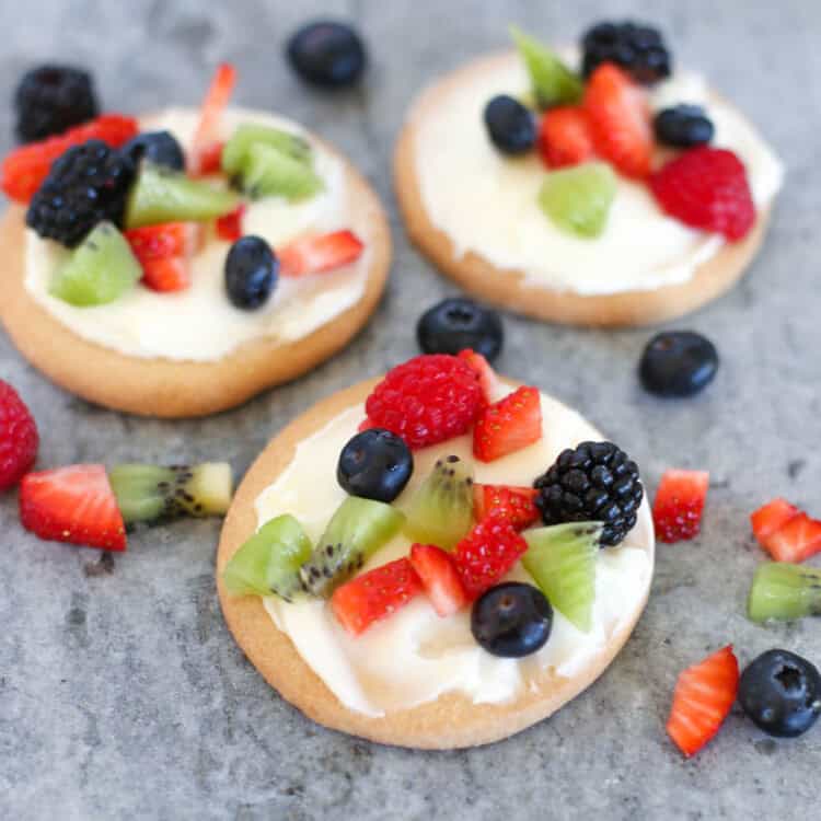 Fruit pizza cookies on a slate serving platter.