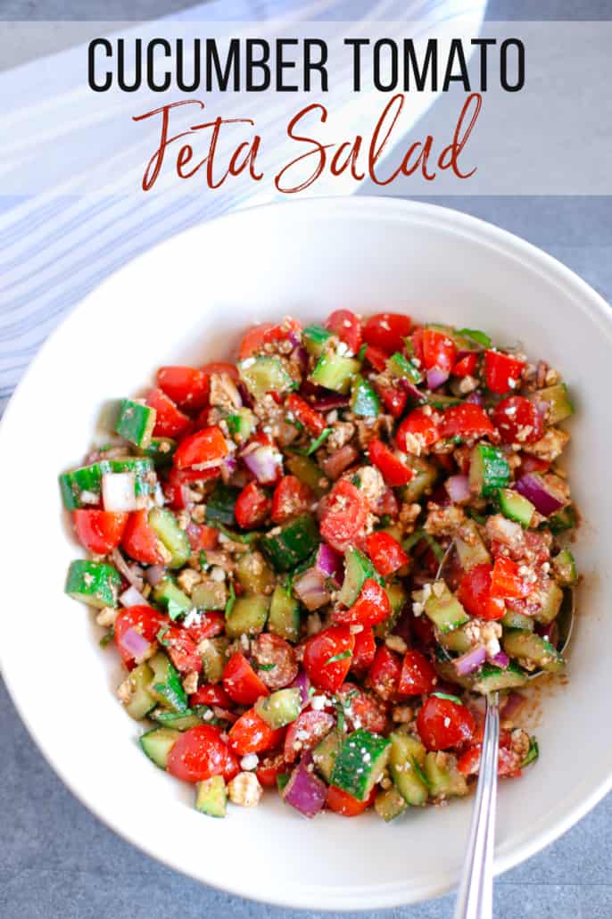 chopped cucumber, tomato, and red onion with feta in a white bowl