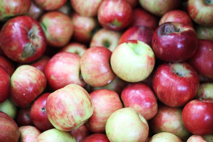 Lots of red apples in a bin.