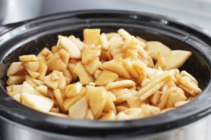 Cut up raw apples, brown sugar, and cinnamon in a crockpot.