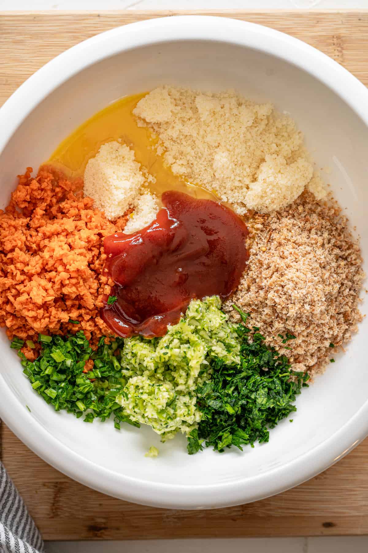 Ingredients for healthy baked meatballs in piles in a bowl.