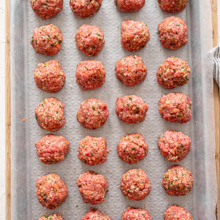 rolled meatballs on a sheet pan