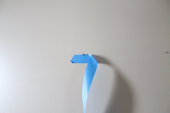 Peeling painters tape off the wall