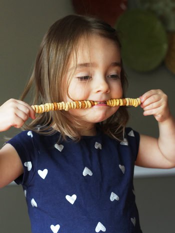 eating cheerios on stick