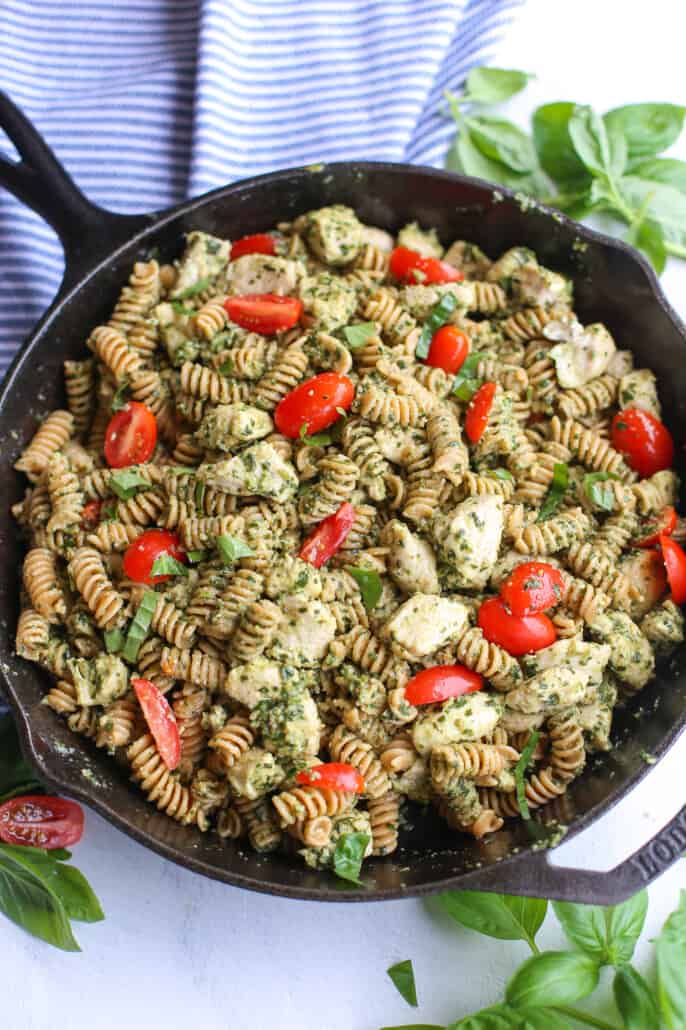 overhead shot of chicken pesto pasta in a cast iron skillet