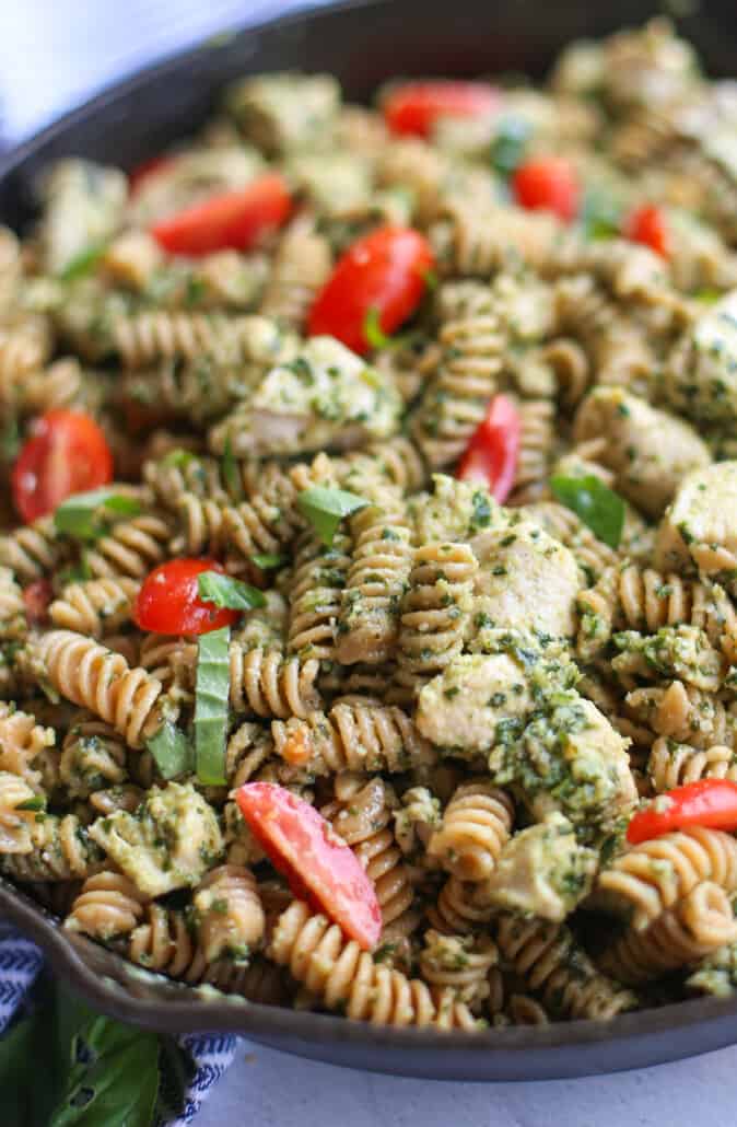 close up shot of finished chicken pesto pasta in skillet