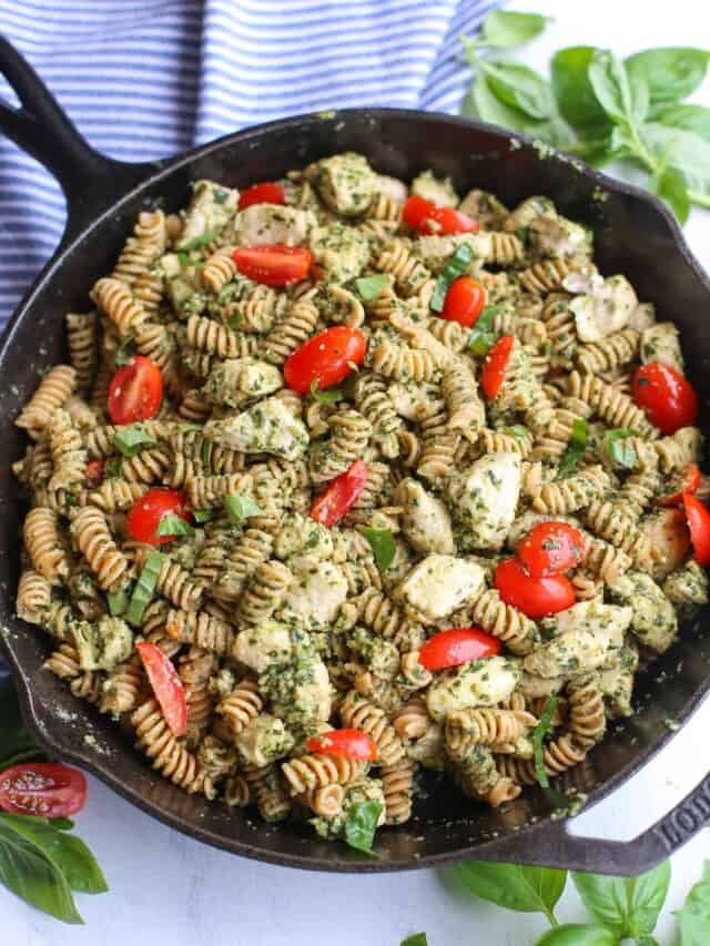 horizontal shot of finished chicken pesto pasta in skillet