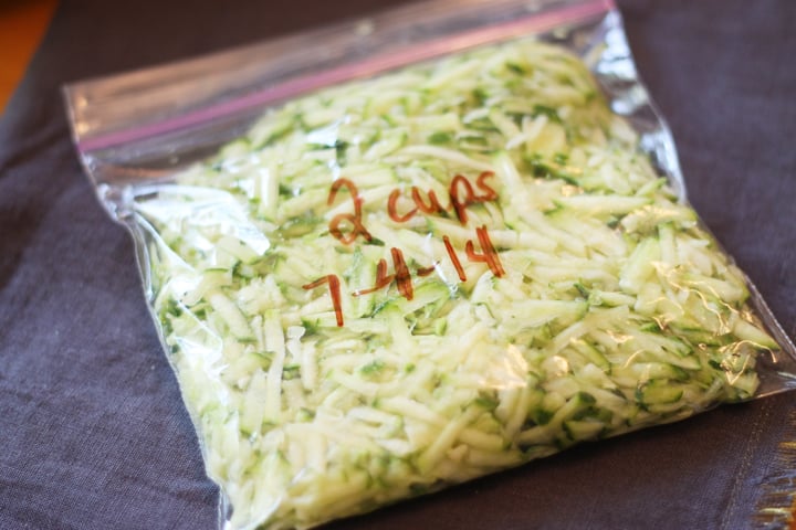 Shredded zucchini in a freezer bag ready to freeze.