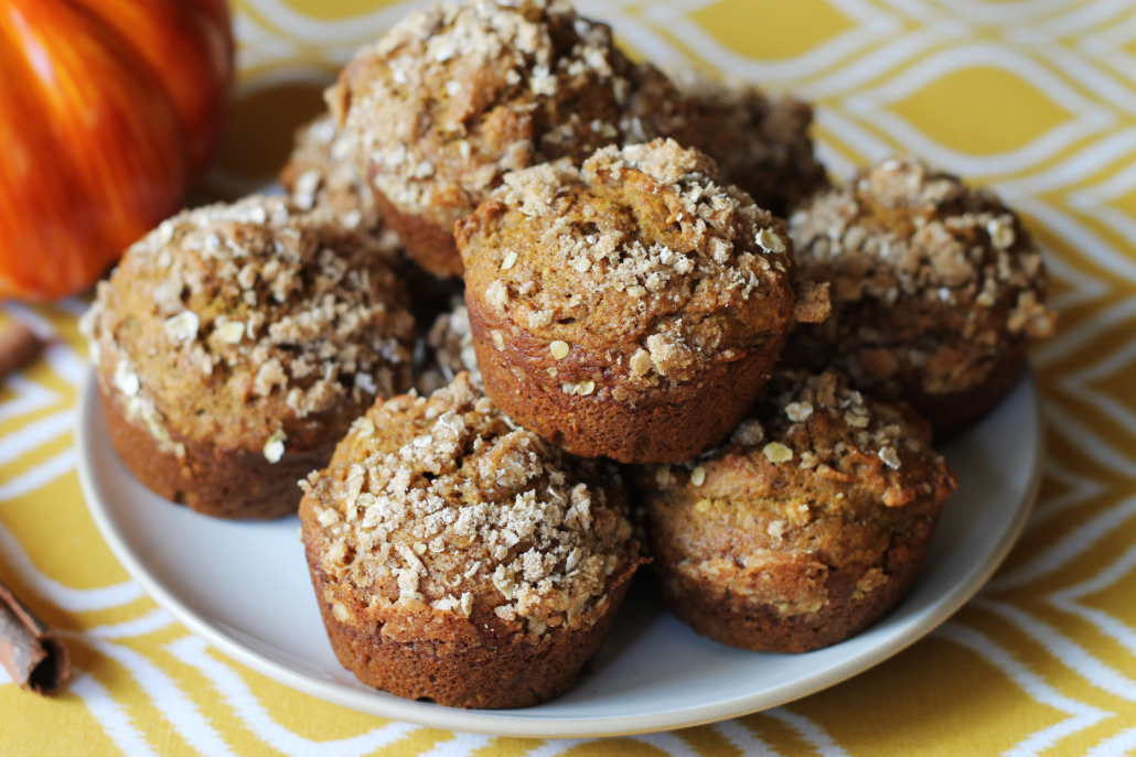 Stack of Pumpkin Muffins with a Crumble Topping on a white plate