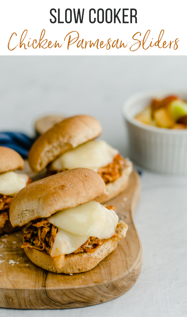 Slow cooker chicken parmesan sliders on a cutting board
