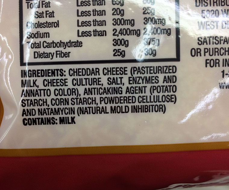 Photo of the ingredient list of store-bought shredded cheese.