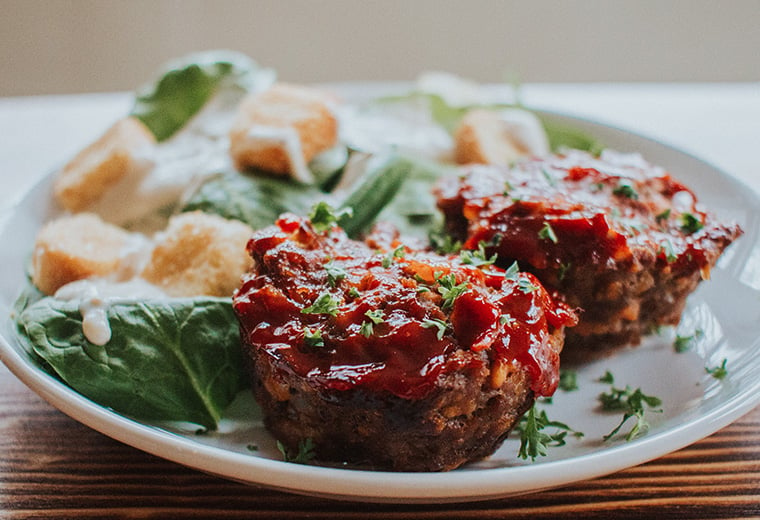 Meatloaf Muffins on a plate with green salad
