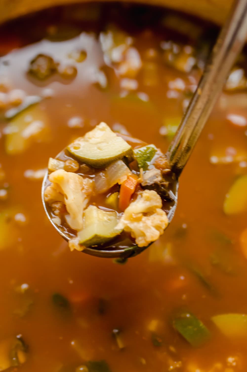 Close up shot of anti-cancer soup in a ladle.