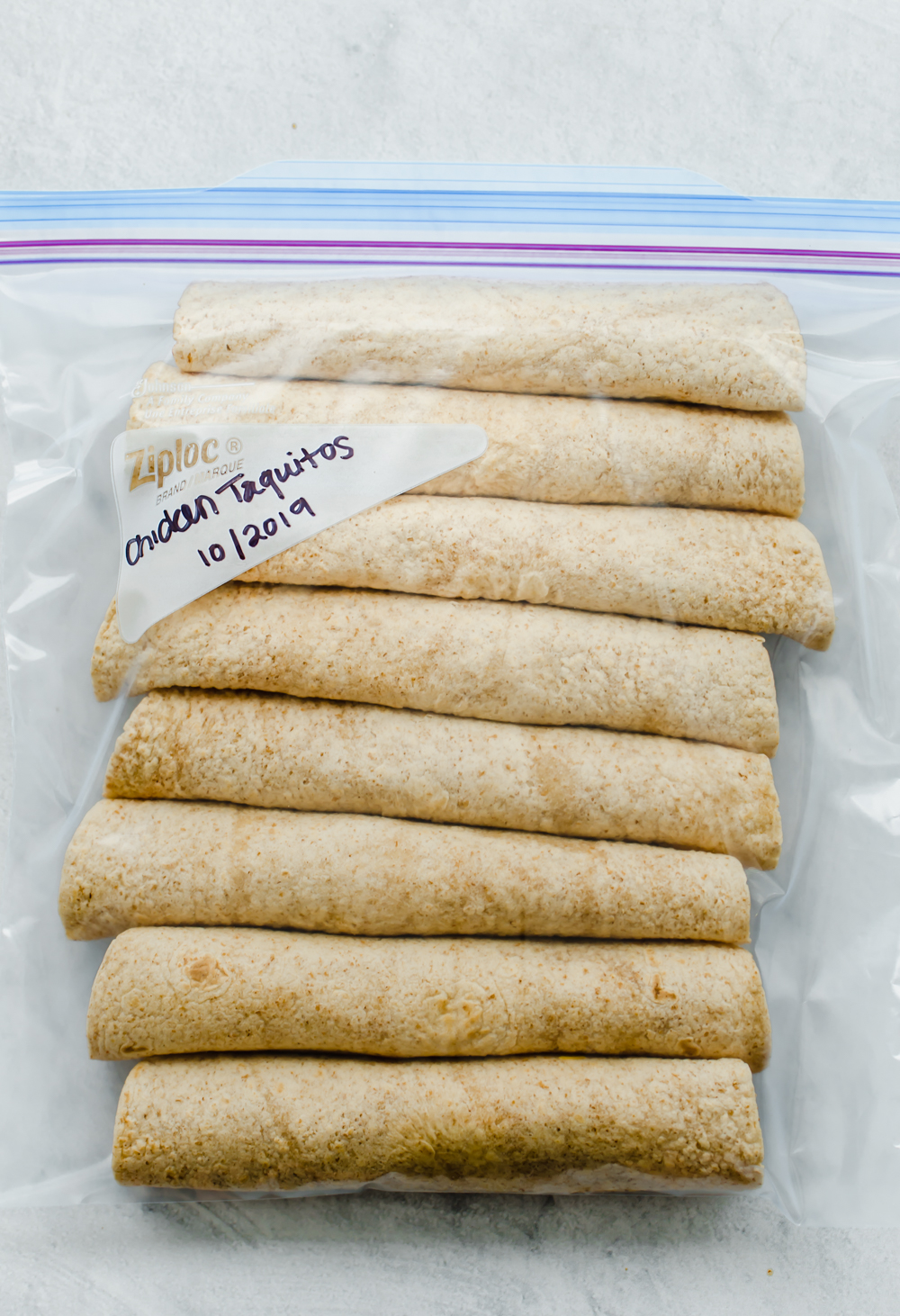 Chicken and cheese taquitos in a freezer bag.