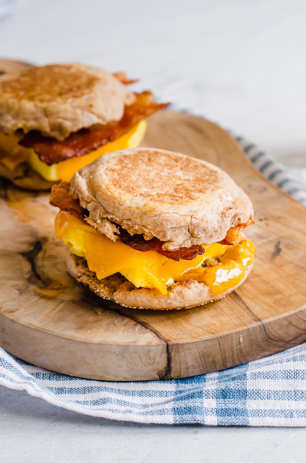 Make ahead breakfast sandwiches on a cutting board.