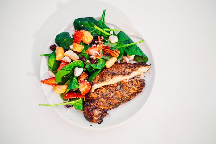 Balsamic Herbed Chicken on a plate with salad