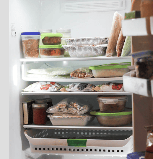 Open freezer stocked with food and freezer meals