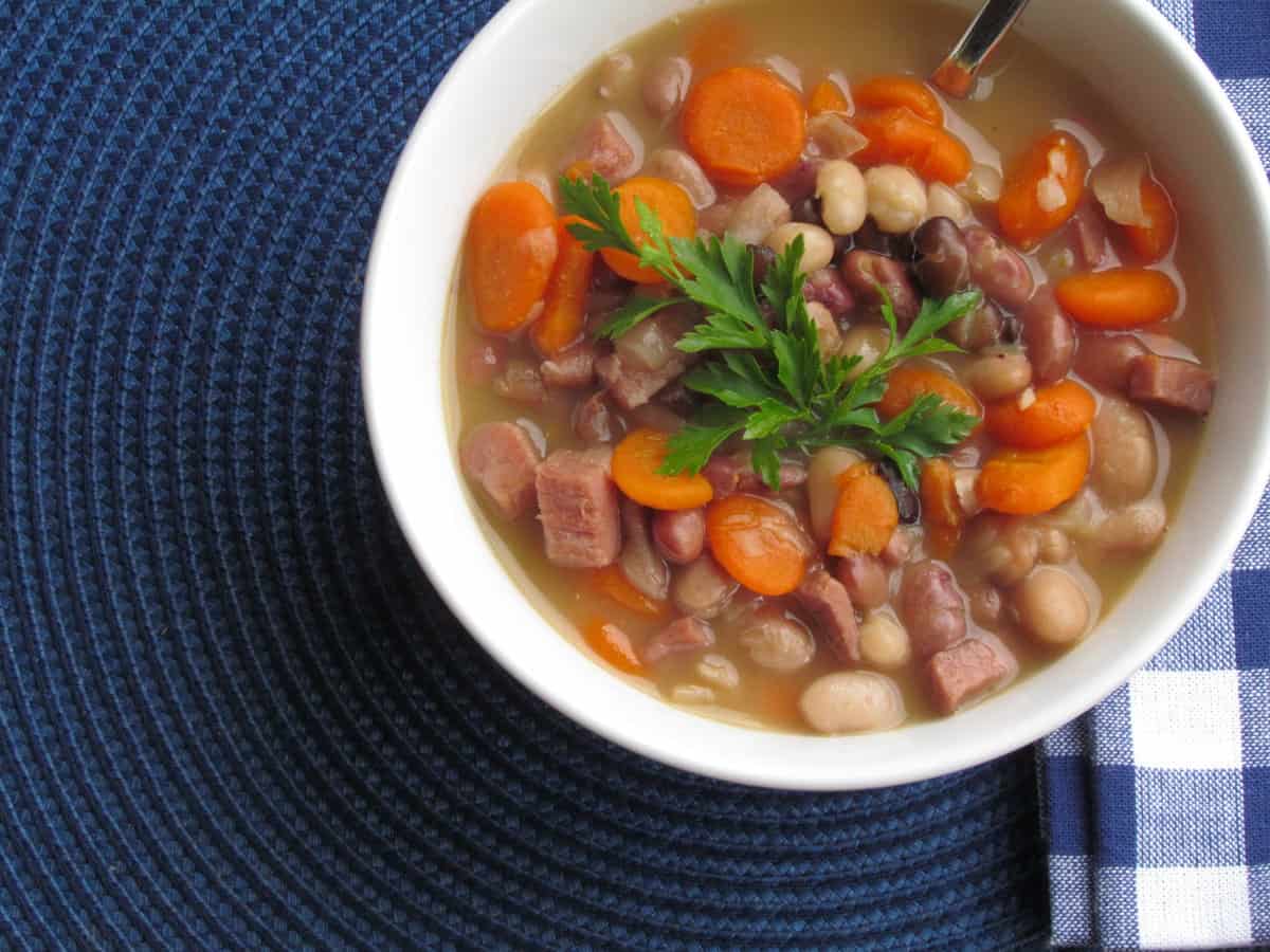 Ham and Bean Soup in a white bowl with spoon.