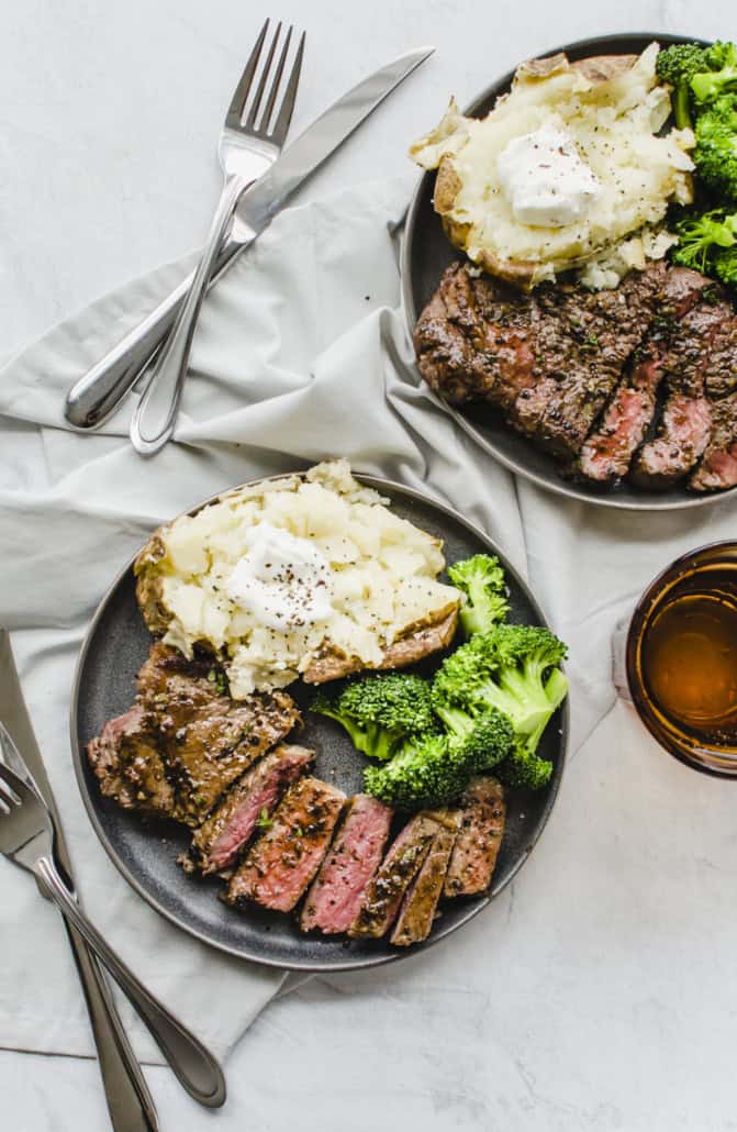 seasoned cooked steak that is sliced on a plate