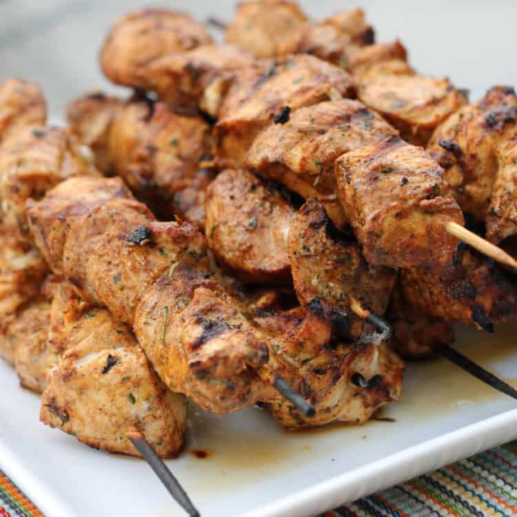 Southwest Grilled Chicken Kabobs lined up on a platter.