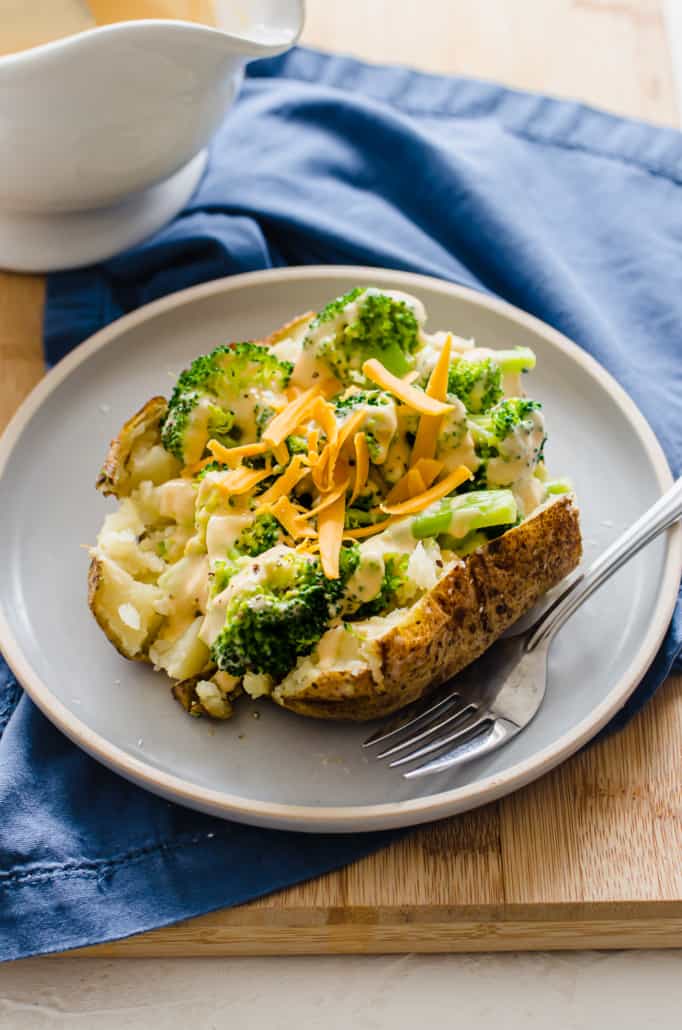 shot of broccoli cheese sauce on a baked potato