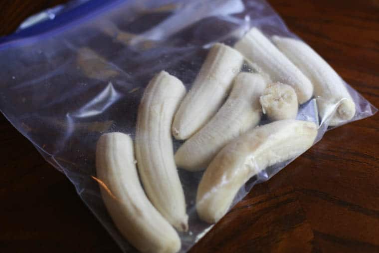 Bananas cut in half inside a freezer-safe baggie for the freezer.