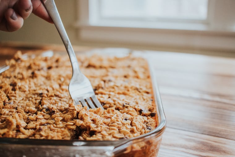 Pumpkin Chocolate Chip Baked Oatmeal in a casserole dish with a fork 