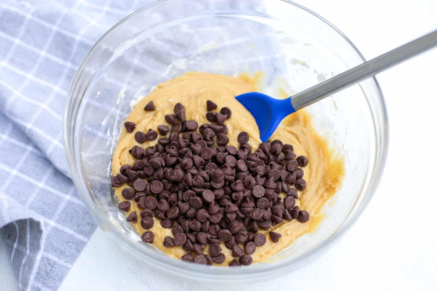 stirring chocolate chips into blondie batter