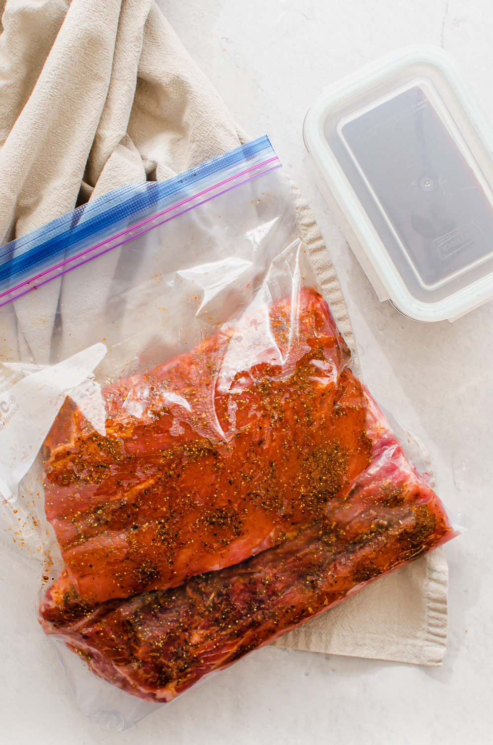 Baby back ribs with a rub in a freezer bag.