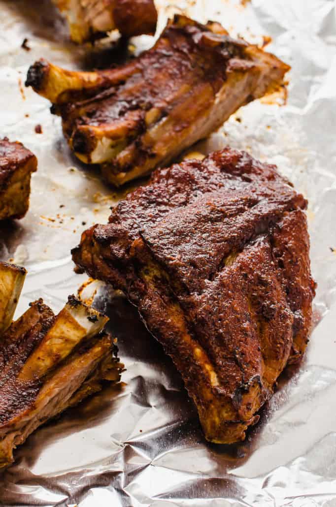 Instant Pot baby back ribs that have been broiled on a sheet pan with BBQ sauce