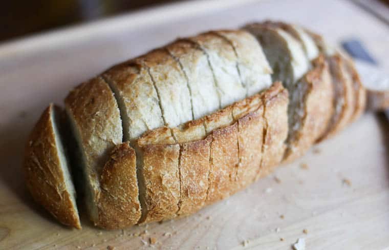 A loaf of French bread sliced about 1/2 inch thick.