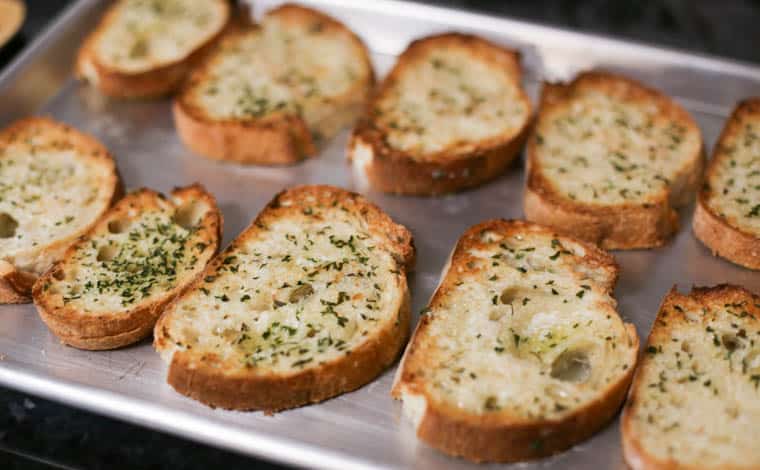 Texas toast on a baking pan just coming out of the oven.